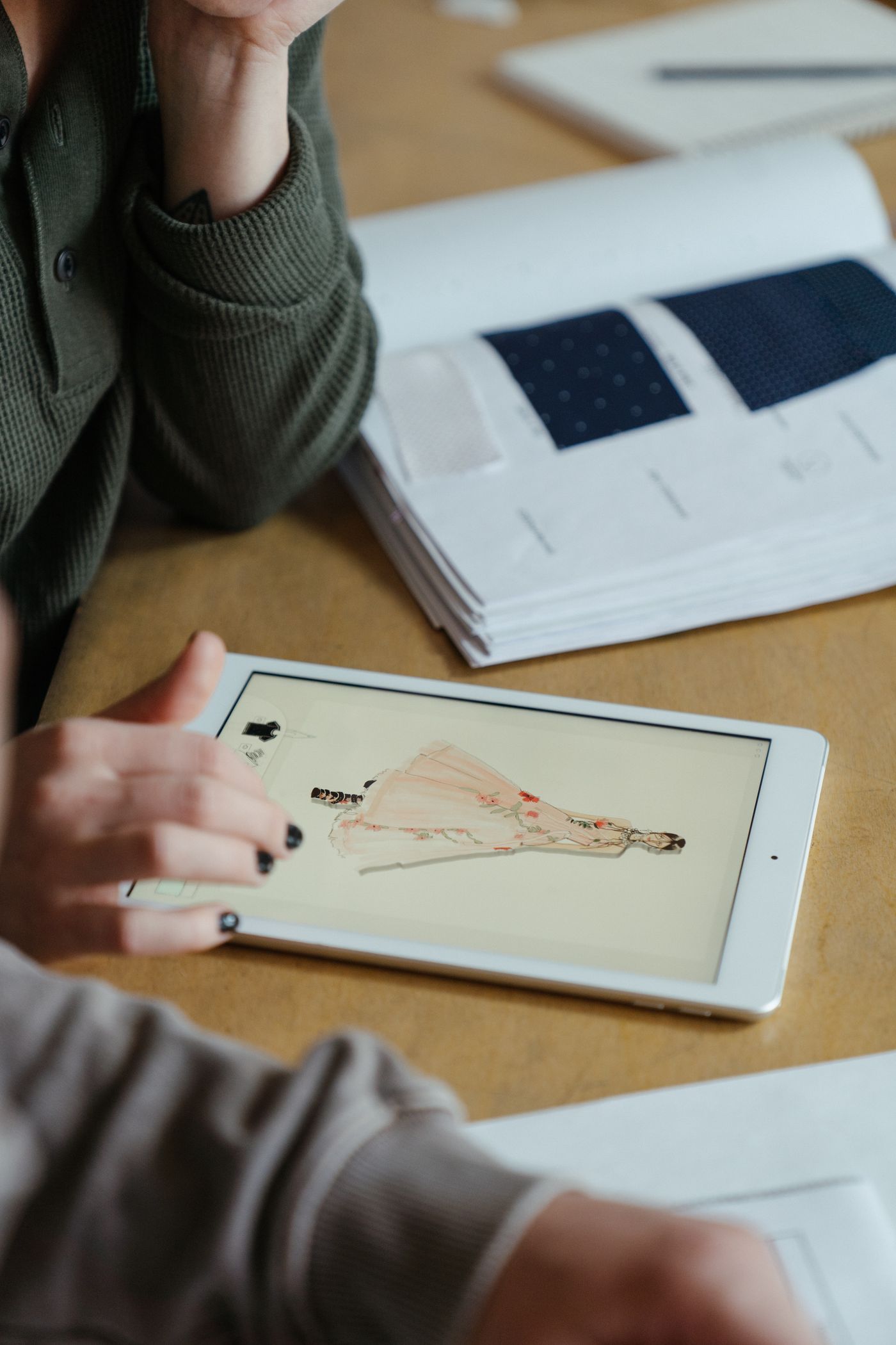 Creative fashion design workspace with fabrics and tools